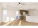 Open floor plan with natural light, hardwood floors, and a modern kitchen with a breakfast bar at 5015 Us Highway 19 # 608, New Port Richey, FL 34652