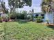 Expansive backyard with mature trees, lush greenery, and a patio area, ideal for outdoor living at 5830 34Th N Ave, St Petersburg, FL 33710