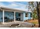 Covered backyard patio with seating, fire pit area, and views of the landscaped yard at 5830 34Th N Ave, St Petersburg, FL 33710