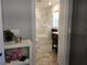 Bright bathroom with marble tiled shower and flooring, modern vanity, and natural light from the window at 5830 34Th N Ave, St Petersburg, FL 33710
