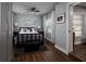 Charming bedroom featuring stylish decor, dark wood floors, ceiling fan and natural light from the windows at 5830 34Th N Ave, St Petersburg, FL 33710