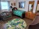 Cozy bedroom with green accents, comfortable seating, vintage furniture, and natural lighting at 5830 34Th N Ave, St Petersburg, FL 33710