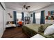 Comfortable bedroom with work desk, hardwood floors, ceiling fan, large windows, and ample space at 5830 34Th N Ave, St Petersburg, FL 33710