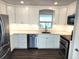 Modern kitchen with stainless steel appliances, white cabinetry, and ample counter space at 5830 34Th N Ave, St Petersburg, FL 33710