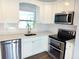 Bright kitchen with white cabinets, stainless steel appliances, and sleek countertops, perfect for culinary enthusiasts at 5830 34Th N Ave, St Petersburg, FL 33710