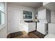 Bright laundry room with washer, dryer, cabinetry, and direct access to the exterior at 5830 34Th N Ave, St Petersburg, FL 33710