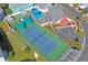 Aerial view featuring pool, tennis and bocce ball courts for community recreation at 6028 Wilds Dr # 6A, New Port Richey, FL 34653