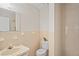 Cozy bathroom featuring neutral tiled walls, granite countertop and sink, with toilet and walk-in shower at 6028 Wilds Dr # 6A, New Port Richey, FL 34653