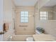 Cozy bathroom featuring a shower-tub combination and neutral tile at 6028 Wilds Dr # 6A, New Port Richey, FL 34653