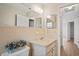 Bathroom featuring neutral tile and a well-lit vanity area at 6028 Wilds Dr # 6A, New Port Richey, FL 34653