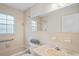 Cozy bathroom featuring a shower-tub combination and neutral tile at 6028 Wilds Dr # 6A, New Port Richey, FL 34653