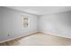 Bright, airy bedroom with neutral walls and floors, and a window with natural light at 6028 Wilds Dr # 6A, New Port Richey, FL 34653