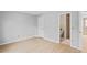 Bedroom featuring light, neutral walls and floors, closet, and view to bathroom at 6028 Wilds Dr # 6A, New Port Richey, FL 34653