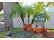 'The Wilds' community sign surrounded by vibrant flowers and lush tropical landscaping at 6028 Wilds Dr # 6A, New Port Richey, FL 34653