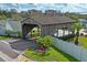 Charming covered bridge entry with lush landscaping, marking 'The Wilds' community at 6028 Wilds Dr # 6A, New Port Richey, FL 34653