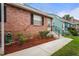The front exterior of a cozy brick home featuring mature landscaping at 6028 Wilds Dr # 6A, New Port Richey, FL 34653