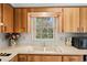 Bright and airy kitchen with wood cabinets and a garden view at 6028 Wilds Dr # 6A, New Port Richey, FL 34653