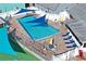 Aerial shot highlighting the community pool with shaded seating and lounge chairs at 6028 Wilds Dr # 6A, New Port Richey, FL 34653