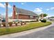 Exterior view of the recreation center with a well-kept lawn at 6028 Wilds Dr # 6A, New Port Richey, FL 34653