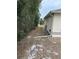 Narrow side yard with utility access at 6419 India Dr, Spring Hill, FL 34608