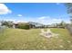 Spacious fenced backyard featuring a screened-in pool and outdoor seating area at 6442 Melacano Ave, Spring Hill, FL 34608