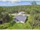 An aerial view of the house, showcasing backyard putting green and extensive lot at 6452 Summit View Dr, Brooksville, FL 34601
