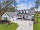 Aerial view of a luxury two story home with large driveway and three car garage at 6452 Summit View Dr, Brooksville, FL 34601
