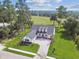 An aerial view of the house with its well-manicured lawn and brick driveway on a golf course at 6452 Summit View Dr, Brooksville, FL 34601