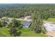 An aerial view of the home and the surrounding wooded neighborhood at 6452 Summit View Dr, Brooksville, FL 34601