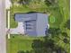 Top down aerial view of a single Gathering house with a putting green in the backyard at 6452 Summit View Dr, Brooksville, FL 34601