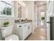 Clean and modern bathroom with a white vanity, black hardware, and a view to an outdoor patio at 6452 Summit View Dr, Brooksville, FL 34601