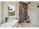 Stylish bathroom featuring a free-standing tub and glass-enclosed shower at 6452 Summit View Dr, Brooksville, FL 34601