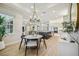 Open-concept living space featuring a dining table with backyard views, connected to kitchen and a living room at 6452 Summit View Dr, Brooksville, FL 34601