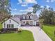 Beautiful home with a well-manicured lawn and brick driveway in a well landscaped yard at 6452 Summit View Dr, Brooksville, FL 34601