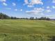 Green golf course with sand traps on a sunny day at 6452 Summit View Dr, Brooksville, FL 34601