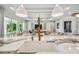 Open concept: view of modern kitchen with a large island connecting to an airy living room with luxury finishes at 6452 Summit View Dr, Brooksville, FL 34601