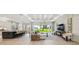 Open-concept living area showcases golf course views, modern finishes and seamless indoor/outdoor living at 6452 Summit View Dr, Brooksville, FL 34601