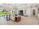 Bright living room features wood floors, modern lighting, and a view to the outdoors at 6452 Summit View Dr, Brooksville, FL 34601