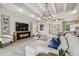 Inviting living room with coffered ceilings, a large sectional and a view that connect to the dining area at 6452 Summit View Dr, Brooksville, FL 34601