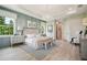 Serene main bedroom with accent wall, modern chandelier, soft color palette and bright light from the windows at 6452 Summit View Dr, Brooksville, FL 34601