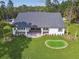 Aerial view of a home with a spacious covered patio and putting green in the backyard at 6452 Summit View Dr, Brooksville, FL 34601