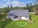 Aerial view of the home's backyard featuring a putting green and covered patio at 6452 Summit View Dr, Brooksville, FL 34601
