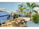 Backyard featuring a boat lift, dock, outdoor picnic area, and coastal landscaping at 6613 Josie Ln, Hudson, FL 34667