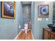 Charming powder room with ocean-themed decor, blue tiled wall, and custom sink at 6613 Josie Ln, Hudson, FL 34667