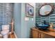 Charming powder room with ocean-themed decor, blue tiled wall, and custom sink at 6613 Josie Ln, Hudson, FL 34667