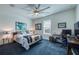 Bright bedroom with a large ceiling fan, desk, and decoratively framed wall art at 6613 Josie Ln, Hudson, FL 34667