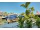 Waterfront property featuring a private boat dock and lift, surrounded by lush tropical landscaping at 6613 Josie Ln, Hudson, FL 34667