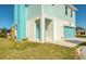 Beautiful coastal home with a turquoise garage door and a covered entryway at 6613 Josie Ln, Hudson, FL 34667
