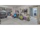 Spacious garage with room for multiple cars and storage, plus a door to a bathroom at 6613 Josie Ln, Hudson, FL 34667