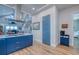 Kitchen with bright cabinets, wood floors and modern lighting at 6613 Josie Ln, Hudson, FL 34667